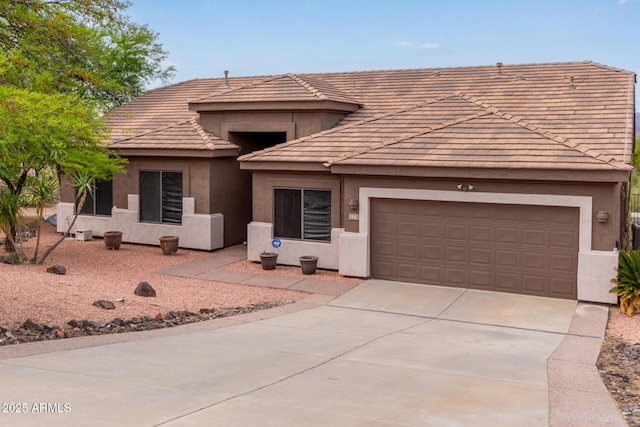 18 E Paint Your Wagon Trl, Phoenix, AZ 85085 - view of front of home with concrete driveway, stucco siding, a garage, and a tiled roof