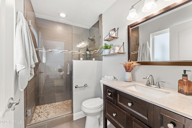 full bath featuring a stall shower, vanity, and toilet