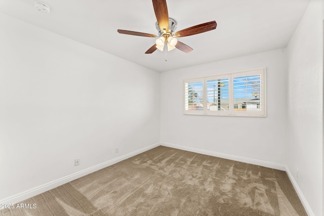 spare room featuring carpet floors, baseboards, and a ceiling fan