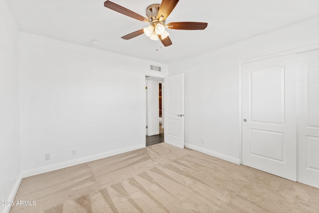 unfurnished bedroom featuring carpet, visible vents, and baseboards