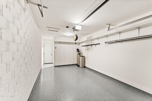 garage with concrete block wall and a garage door opener