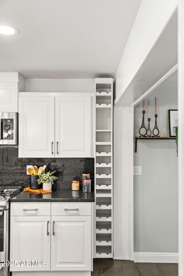 bar with stainless steel appliances, wood finished floors, baseboards, and tasteful backsplash