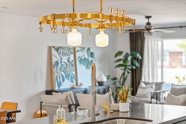 interior space with hanging light fixtures, stone countertops, and ceiling fan with notable chandelier