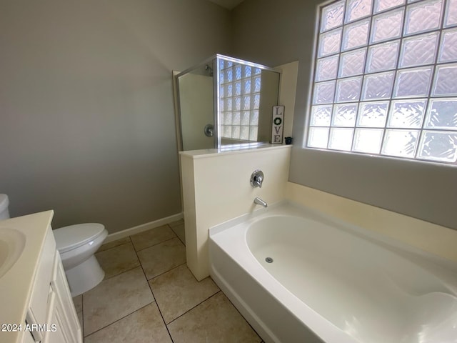 full bathroom with vanity, tile patterned floors, toilet, and separate shower and tub