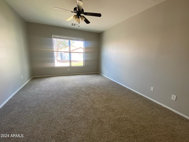 carpeted spare room with ceiling fan