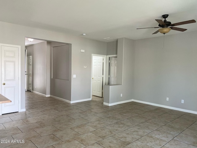 tiled empty room with ceiling fan