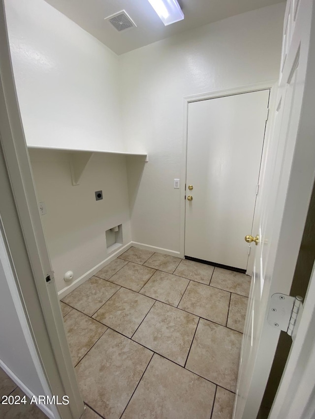 laundry room with light tile patterned flooring and hookup for an electric dryer