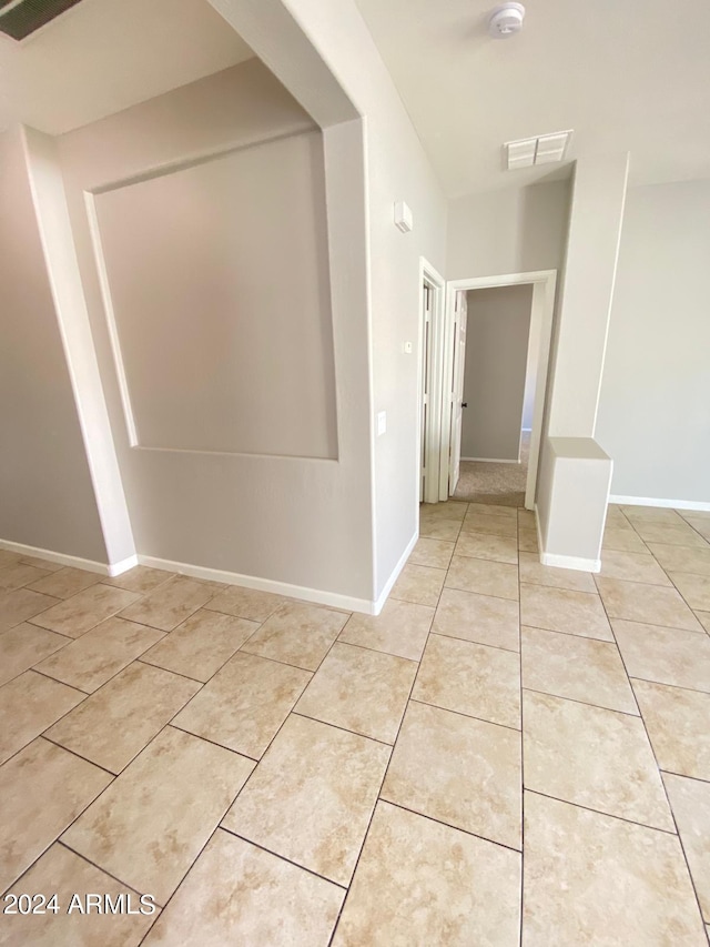 corridor with light tile patterned floors