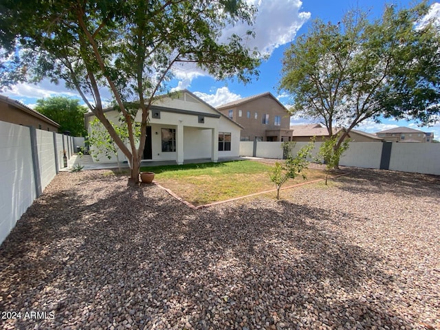 rear view of property with a yard