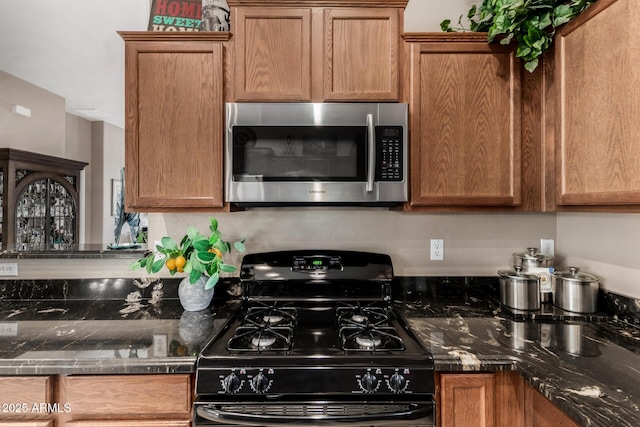 6202 E Mckellips Rd Unit 183, Mesa, AZ 85215 - kitchen featuring stainless steel microwave, black gas stove, and brown cabinetry