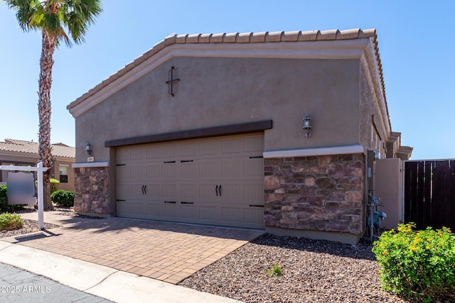 6202 E Mckellips Rd Unit 183, Mesa, AZ 85215 - view of front facade featuring stone siding, stucco siding, decorative driveway, and a tile roof