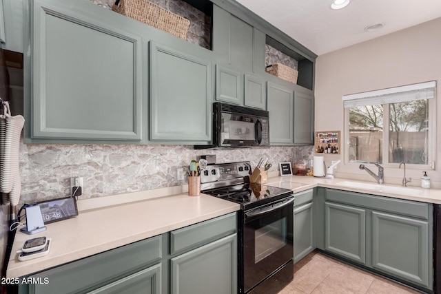 kitchen featuring sink, light tile patterned floors, decorative backsplash, and black appliances