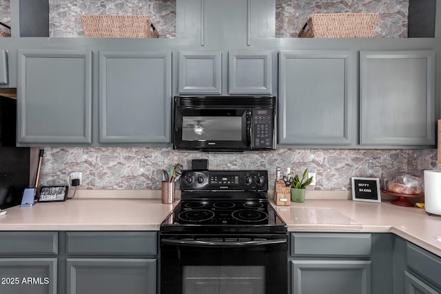 kitchen featuring backsplash, gray cabinets, and black appliances