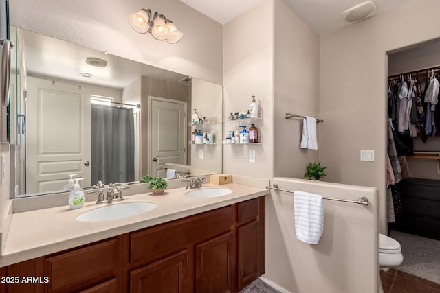 bathroom featuring vanity, tile patterned floors, and toilet