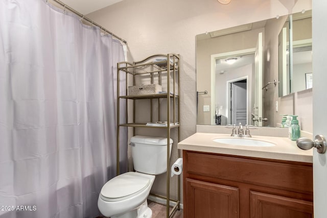 bathroom featuring vanity, a shower with shower curtain, and toilet