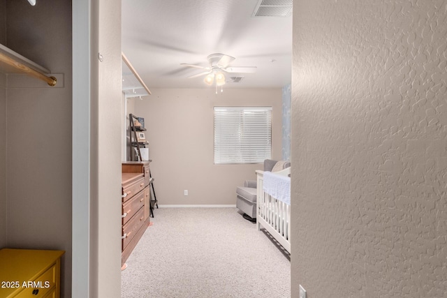 bedroom featuring light colored carpet and ceiling fan