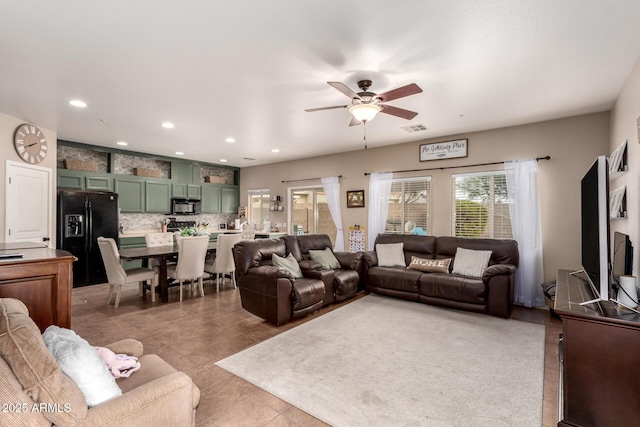 tiled living room with ceiling fan