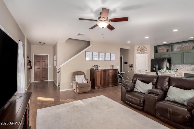 living room featuring dark tile patterned floors and ceiling fan