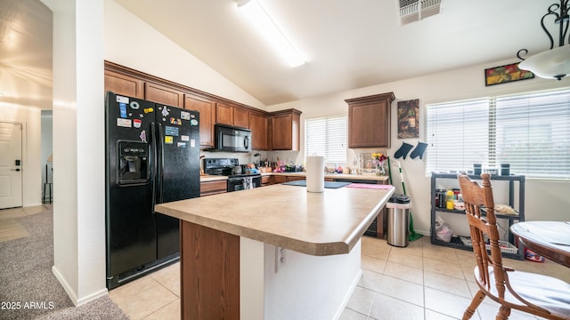 23941 N High Dunes Dr, Florence, AZ 85132 - kitchen with light countertops, lofted ceiling, a kitchen island, light tile patterned flooring, and black appliances