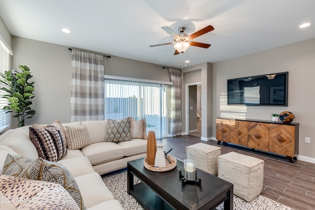 living room with ceiling fan, wood-type flooring, and plenty of natural light