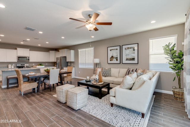 living room featuring hardwood / wood-style flooring and ceiling fan