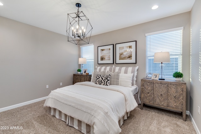 carpeted bedroom with a chandelier