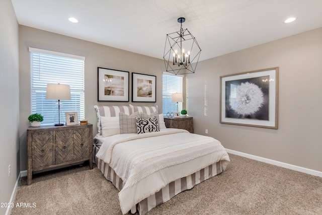 bedroom with carpet flooring and an inviting chandelier