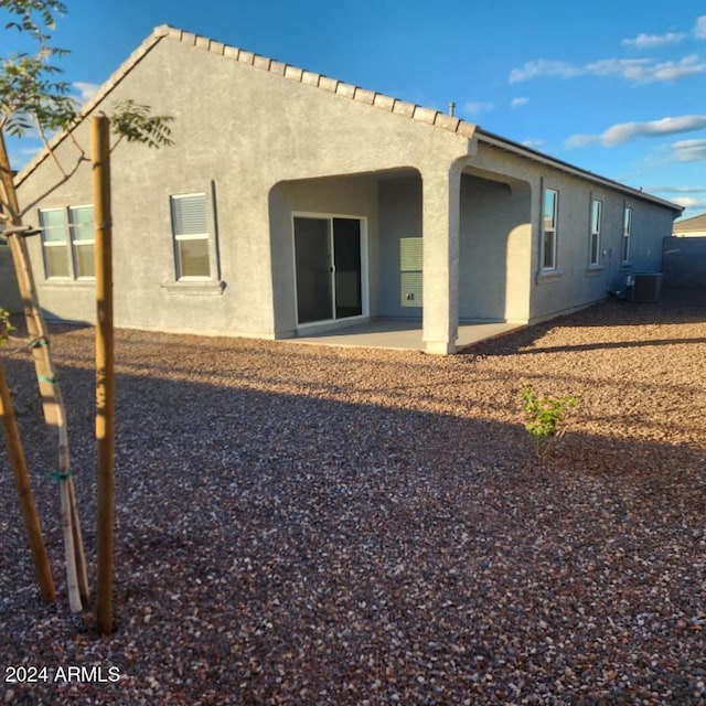 back of house featuring cooling unit and a patio area