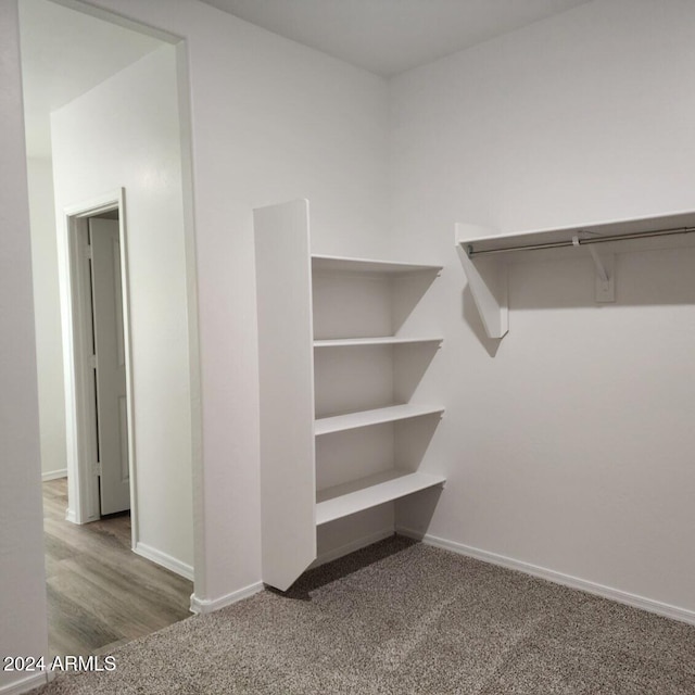 walk in closet featuring hardwood / wood-style flooring