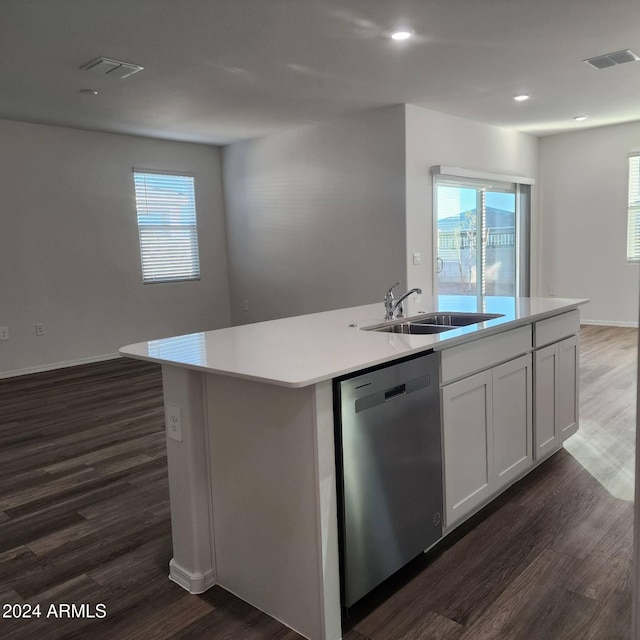 kitchen with a center island with sink, sink, white cabinetry, dark wood-type flooring, and dishwasher