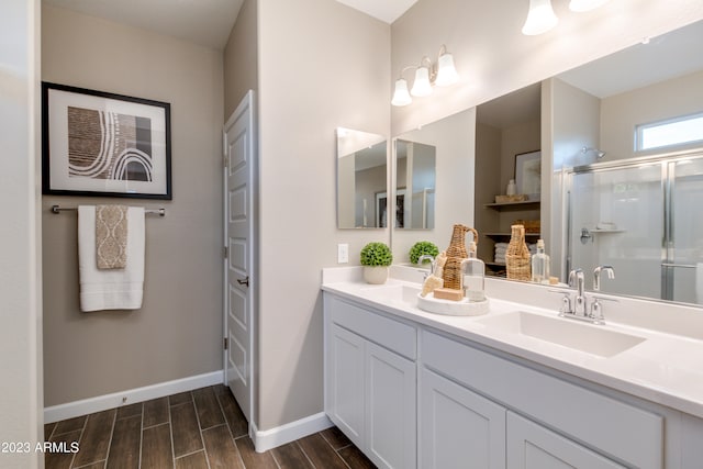 bathroom featuring walk in shower, wood-type flooring, and vanity