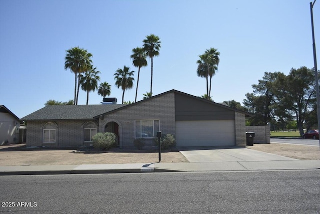 12601 N 34th St, Phoenix, AZ 85032 - ranch-style home with a garage, brick siding, and driveway