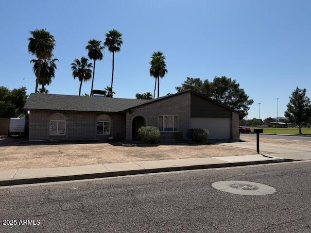 12601 N 34th St, Phoenix, AZ 85032 - single story home featuring brick siding, an attached garage, and concrete driveway