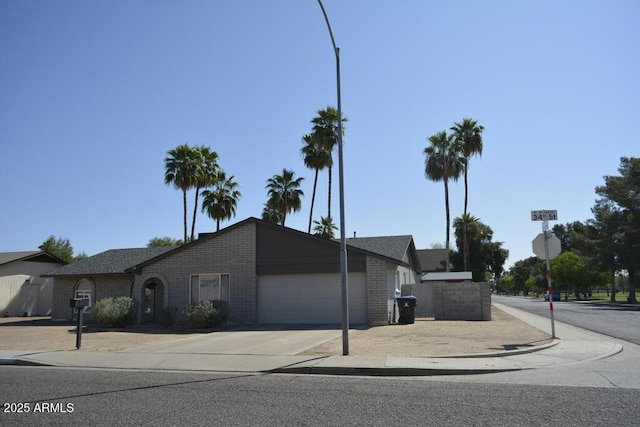 12601 N 34th St, Phoenix, AZ 85032 - view of front facade with a garage, driveway, and brick siding