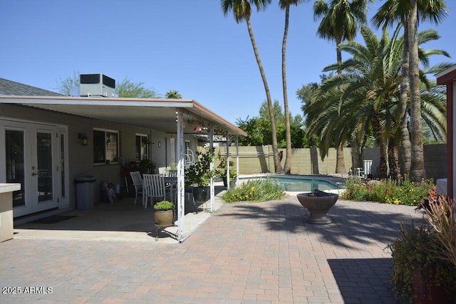 12601 N 34th St, Phoenix, AZ 85032 - view of patio featuring central air condition unit, french doors, a fenced in pool, and fence private yard