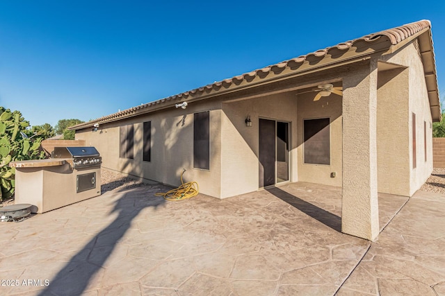 19576 N Portarosa Ct, Maricopa, AZ 85138 - rear view of house featuring an outdoor kitchen, a ceiling fan, stucco siding, a patio, and a tiled roof
