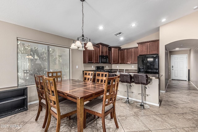 19576 N Portarosa Ct, Maricopa, AZ 85138 - dining room with arched walkways, lofted ceiling, a chandelier, recessed lighting, and baseboards