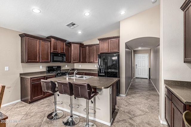 19576 N Portarosa Ct, Maricopa, AZ 85138 - kitchen with black appliances, arched walkways, lofted ceiling, a sink, and baseboards