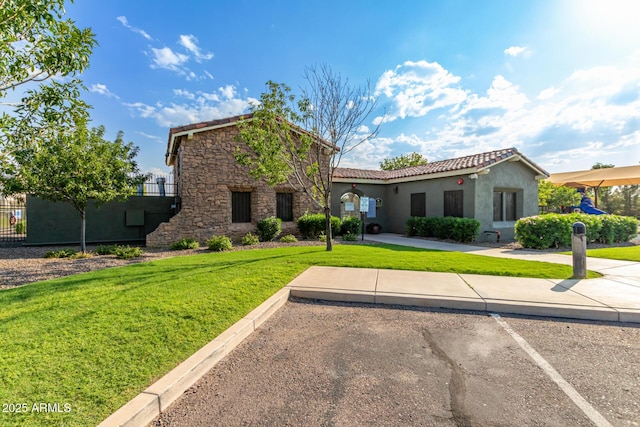 19576 N Portarosa Ct, Maricopa, AZ 85138 - view of front of home featuring stone siding, a tile roof, stucco siding, and uncovered parking