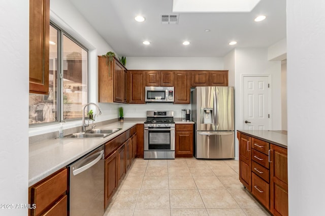 kitchen with visible vents, appliances with stainless steel finishes, light tile patterned flooring, a sink, and recessed lighting