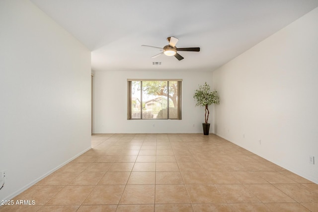 empty room with light tile patterned floors, ceiling fan, and visible vents