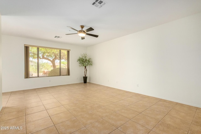 empty room with light tile patterned floors, visible vents, and a ceiling fan