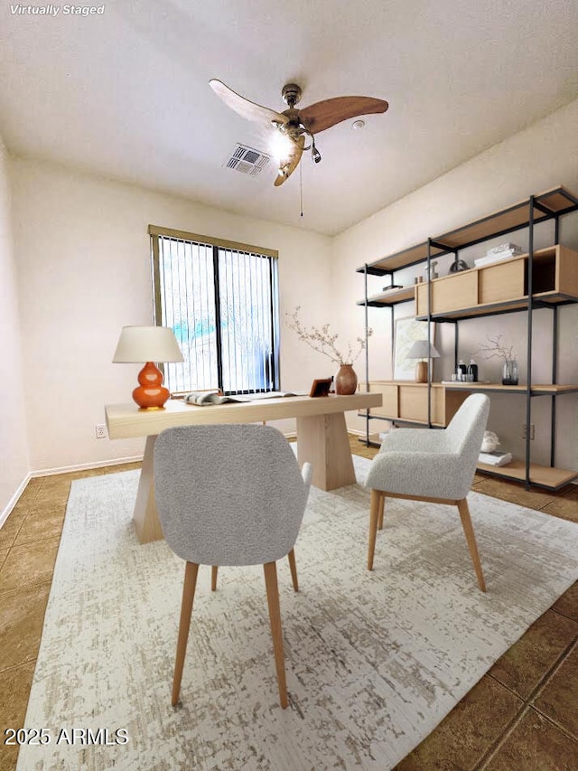 tiled living room featuring a ceiling fan, visible vents, and baseboards