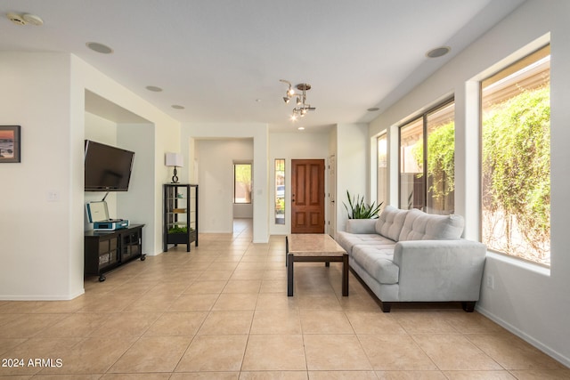 tiled living room featuring an inviting chandelier