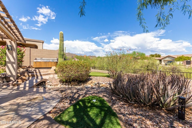 view of yard featuring a fenced backyard, a patio, and a hot tub