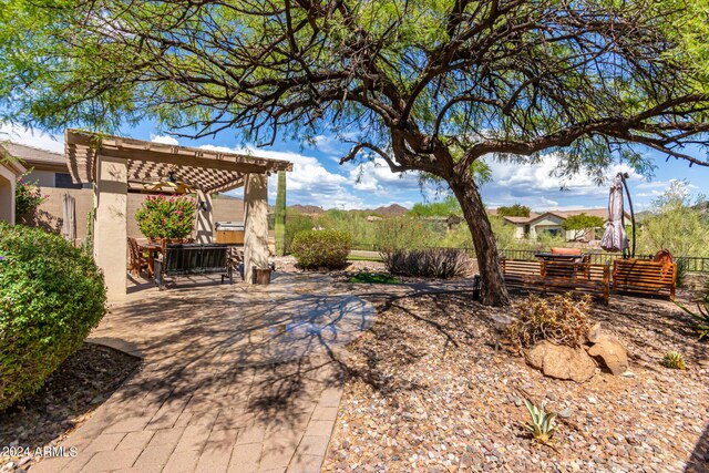 view of yard with fence, a pergola, and a patio