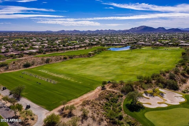 bird's eye view featuring view of golf course and a water and mountain view