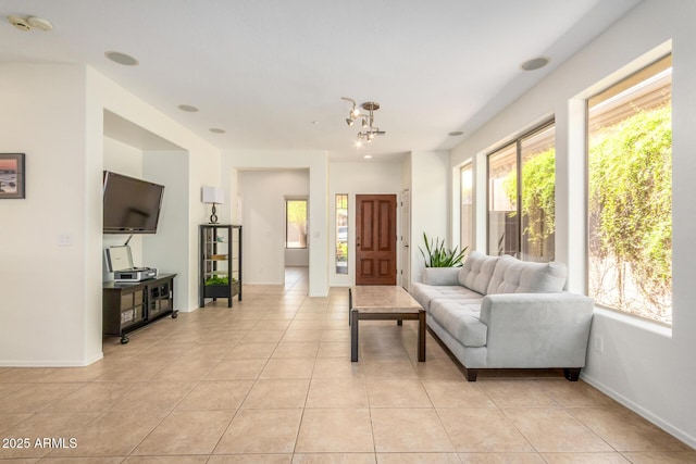 living room featuring light tile patterned floors and baseboards