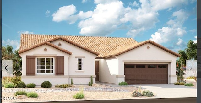 mediterranean / spanish-style home with stucco siding, driveway, an attached garage, and a tile roof