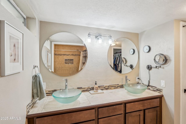 bathroom with vanity and a textured ceiling